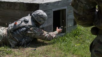 Cadet crawls and throws a grenade.