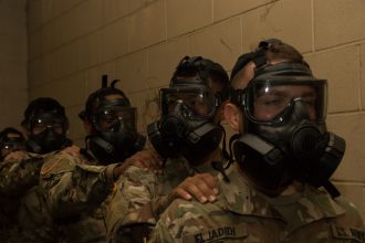 Cadets wear their gas masks inside the gas chamber.