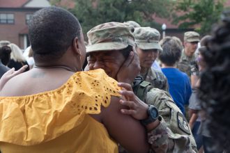 A Cadet cries and greets her family.