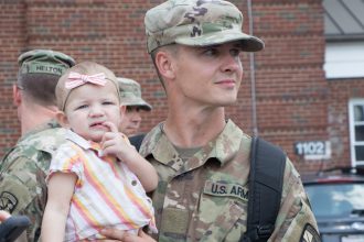 A Cadet holds his daughter.